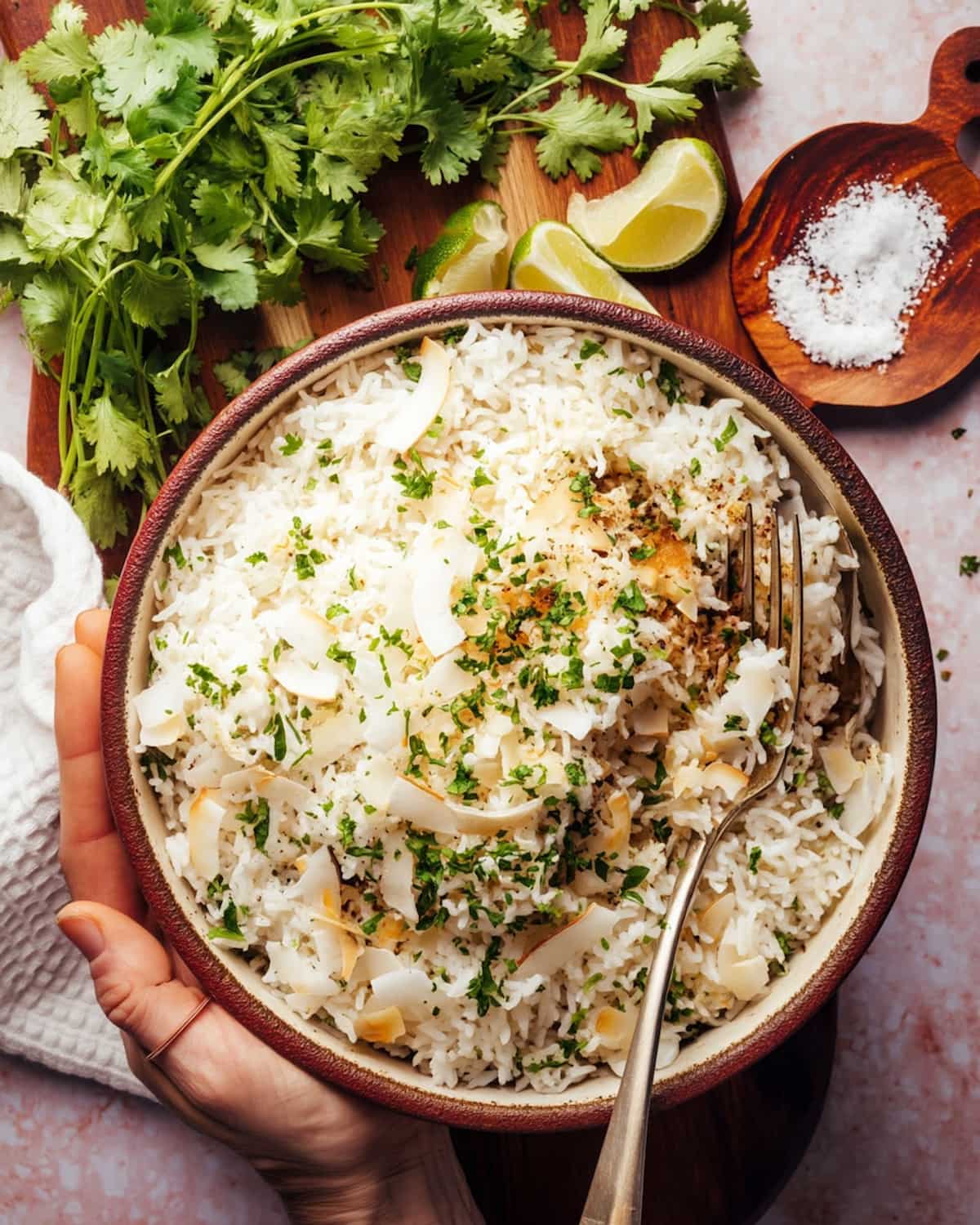 Instant Pot Coconut Jasmine Rice Pudding topped with toasted coconut flakes and fresh herbs.