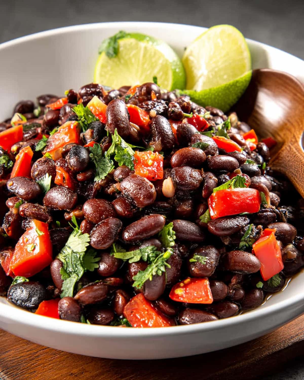 black beans Instant Pot recipe with red peppers, fresh cilantro, and lime wedges.