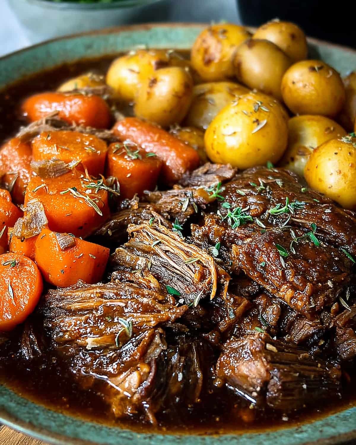 chuck roast Instant Pot recipe with juicy beef, baby potatoes, and carrots.