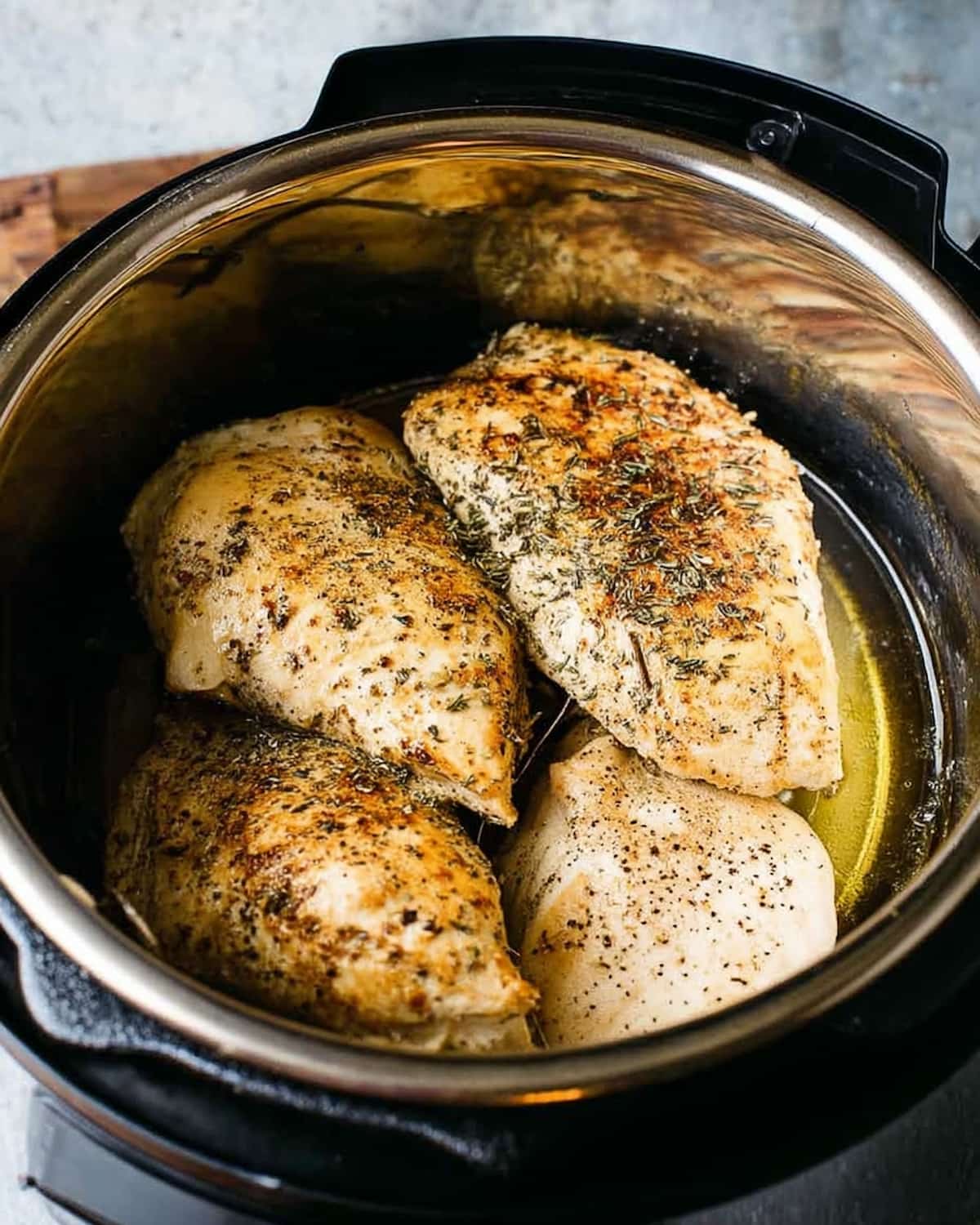 Instant Pot chicken breast seasoned with herbs and spices.