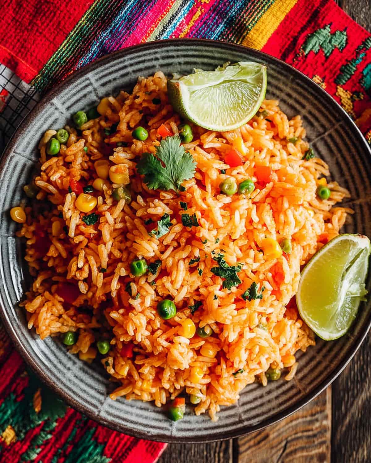 Instant Pot Mexican rice with peas, corn, and carrots, garnished with fresh herbs.