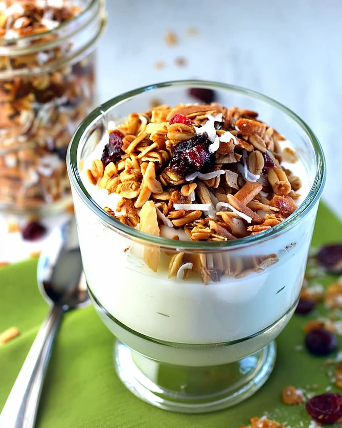 Instant Pot vanilla yogurt recipe topped with crunchy granola, dried cranberries, and shredded coconut.