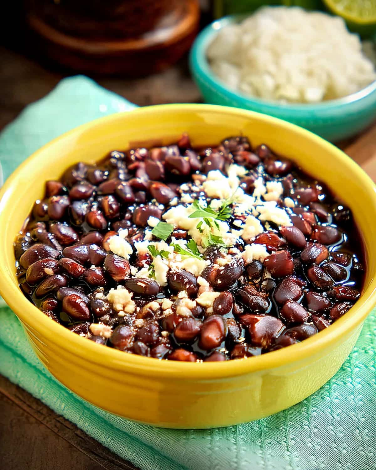 Instant Pot Mexican black beans topped with crumbled cheese and fresh cilantro.
