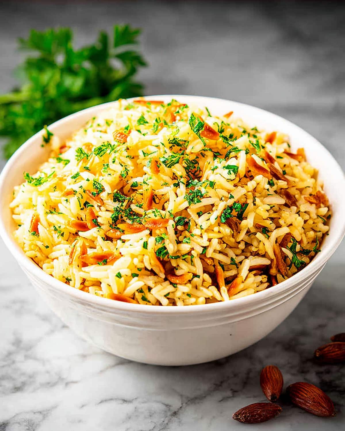 Instant Pot spicy rice pilaf with golden toasted almonds, fresh herbs, and fluffy basmati rice.