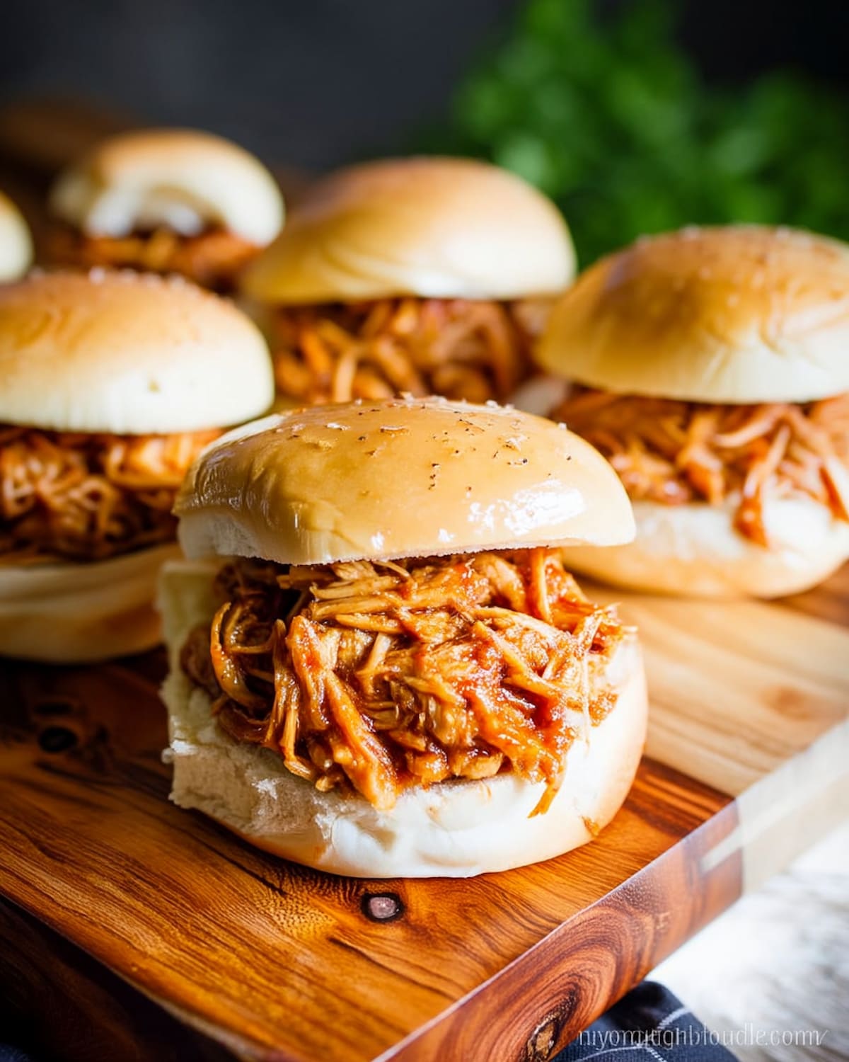 Instant Pot BBQ chicken sliders with soft buns filled with tender shredded chicken in smoky sauce.